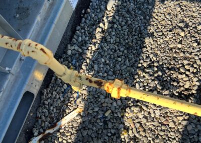 This is a gas line that is rusting and needs to be repainted. Gas code requires all commercial gas pipe to be painted yellow with rust paint.